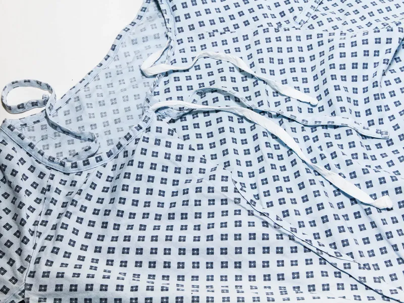 Close up of a hospital gown in blue patterned fabric