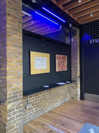 two framed placards on a black wall