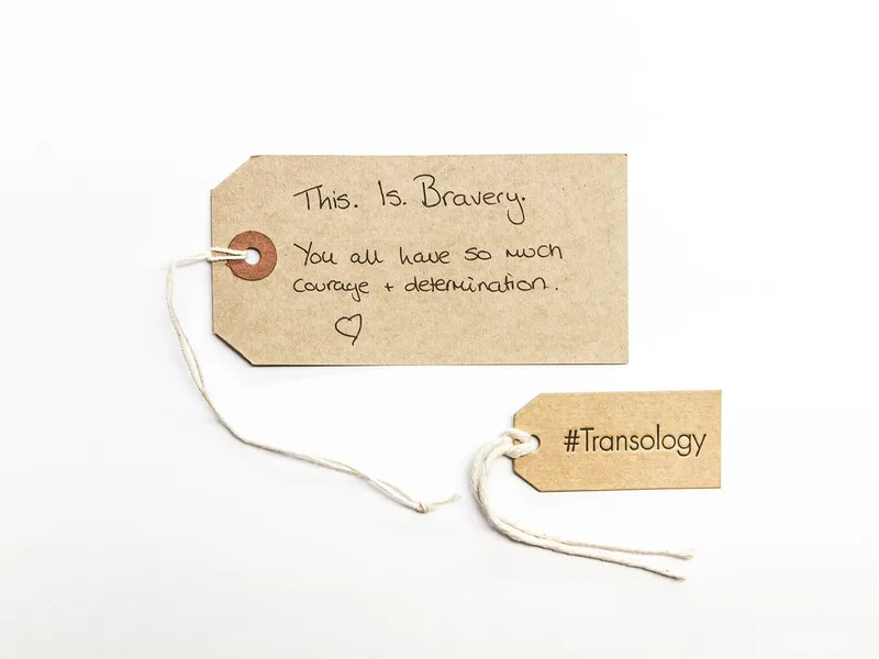 A luggage tag with a transology tag next to it