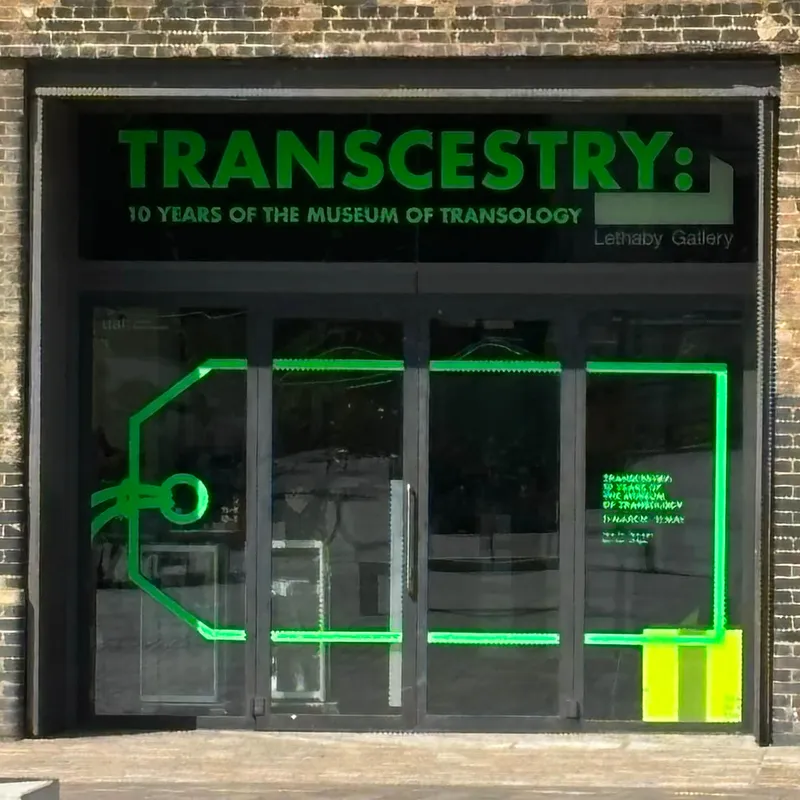 A large set of exhibition space doors with a large luggage tag decal