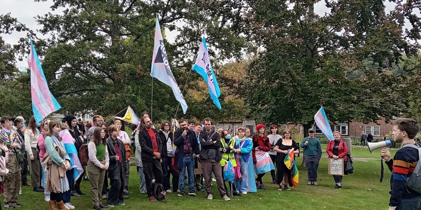 picture of protestors holding banners on a field