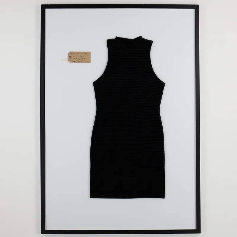 A black sleeveless dress in a frame