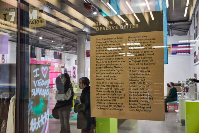 The Trans Kids Deserve Better exhibit through a window