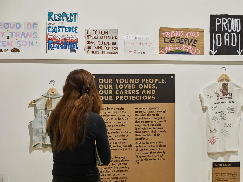 A person looking at a wall of placards