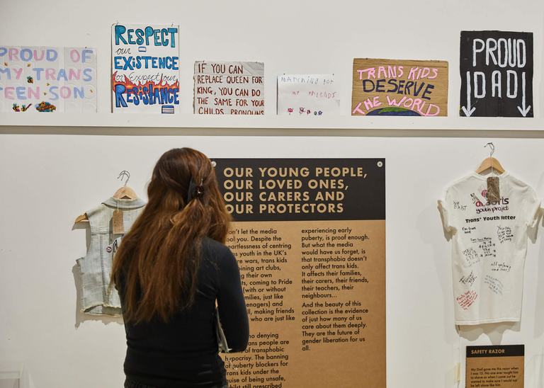 A person looking at a wall of placards
